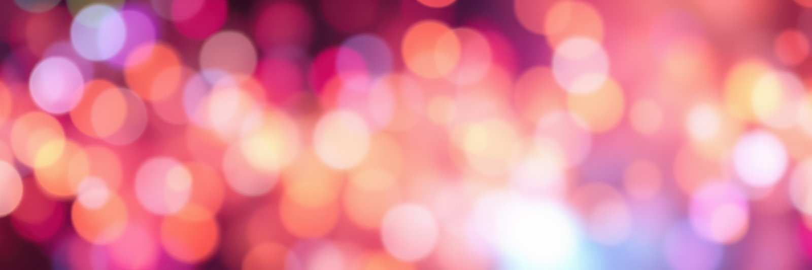Colorful bokeh lights create a festive atmosphere during a night celebration in an urban setting